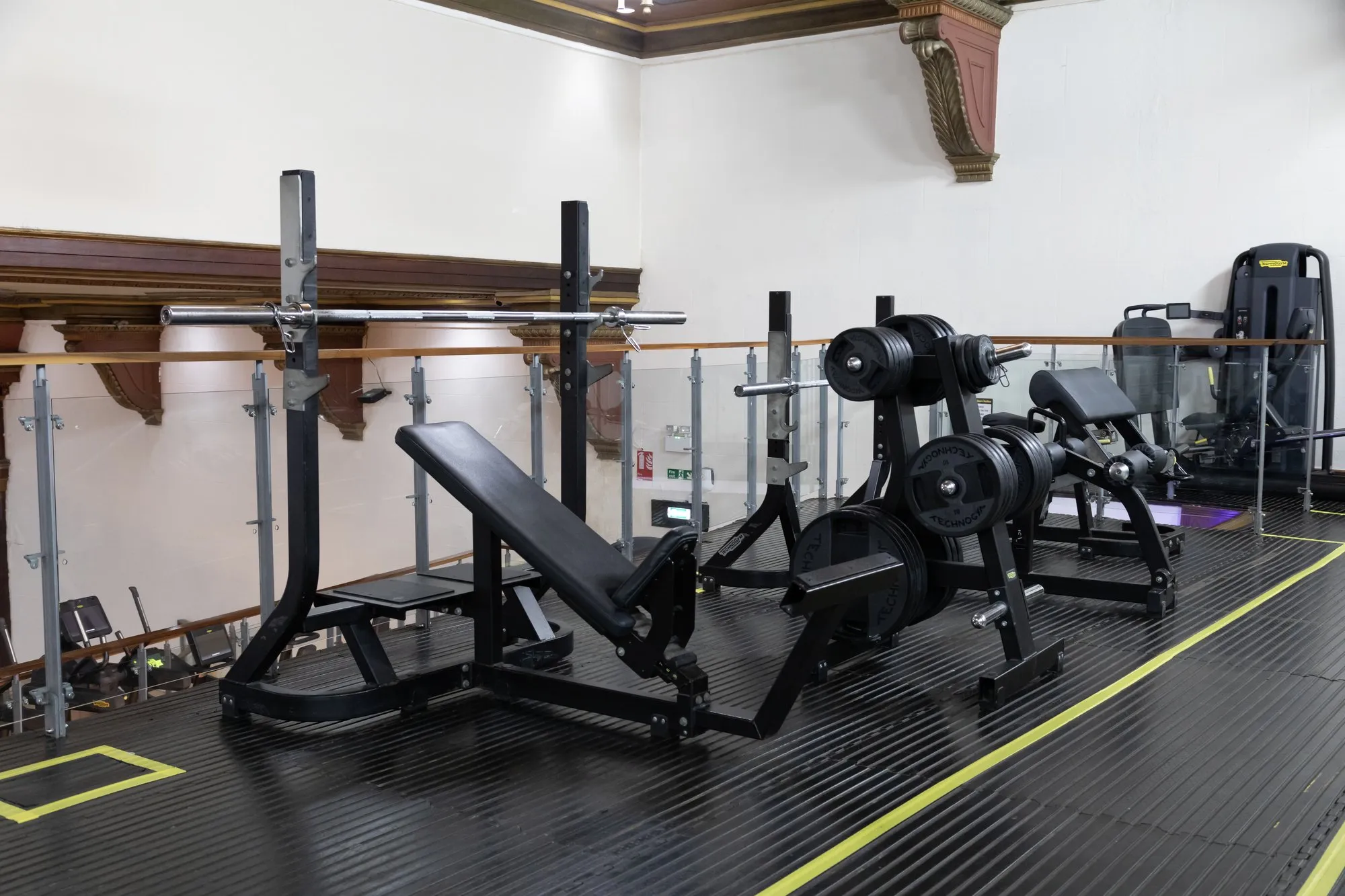 Plate-loaded machines and benches at Gold's Gym Harrow